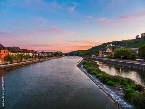 Image of a red clouds from the view of the river in the middle of the city. © Mustafa Kurnaz/Wirestock Creators