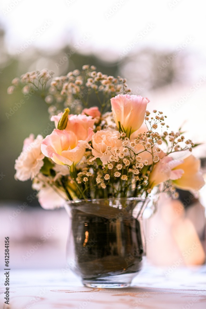 Vertical closeup of a beautiful bouquet in a vase for wedding