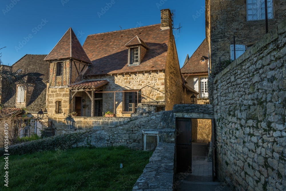 Traditional medieval house against a blue sky in Sarlat, France