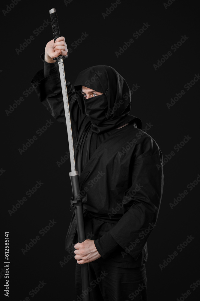 Male ninja with sword on black background Male ninja with sword on black background