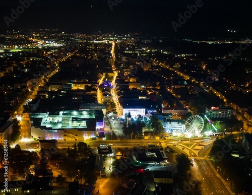 Aerial view of streets and buildings of a city illuminated at night