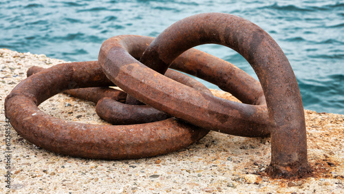 Rusty mooring hook for vessels on concrete