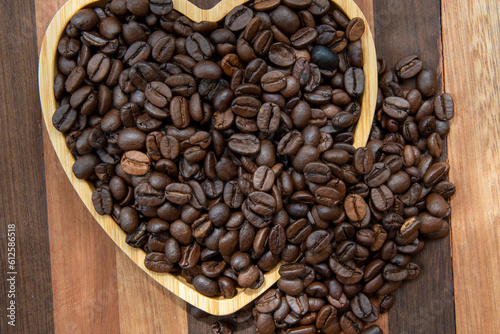 coffee beans in heart-shaped tra,y representing love of coffee photo