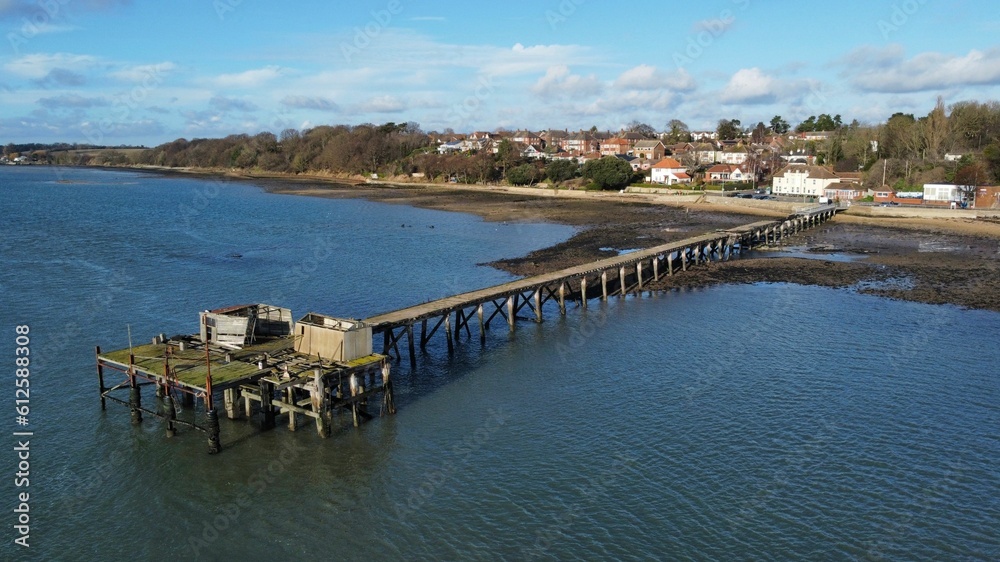 Drone shot of a wooden dock near the shore of a sea