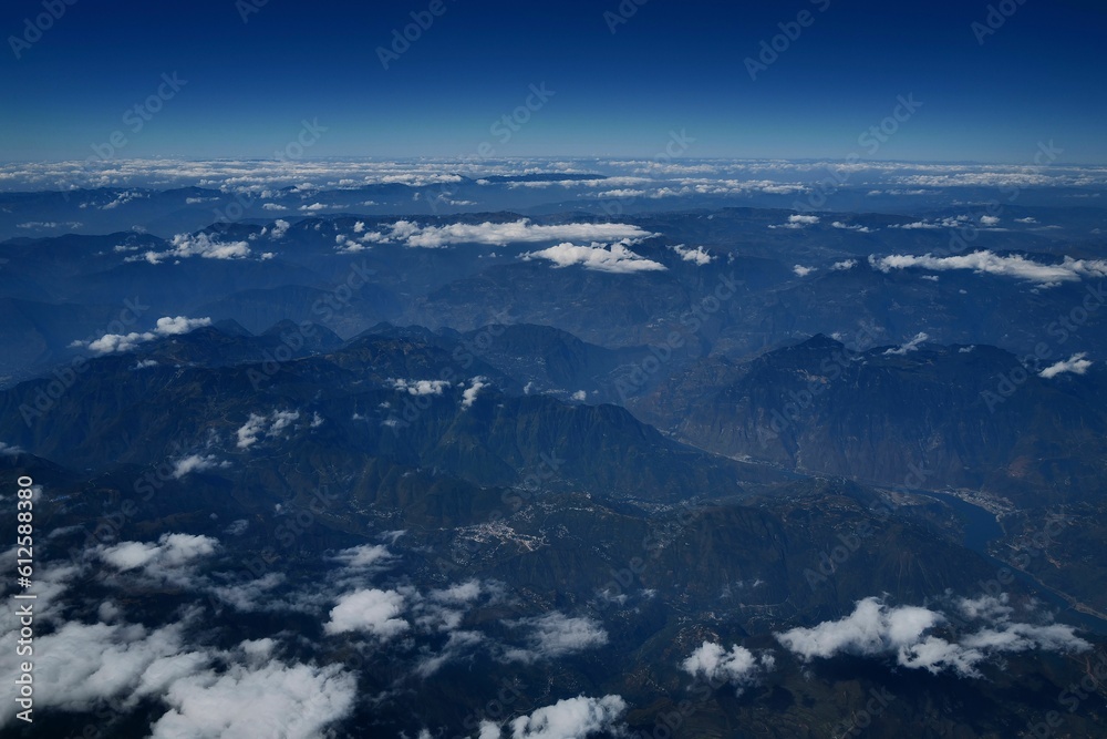 Aerial shot of clouds over the mountains.