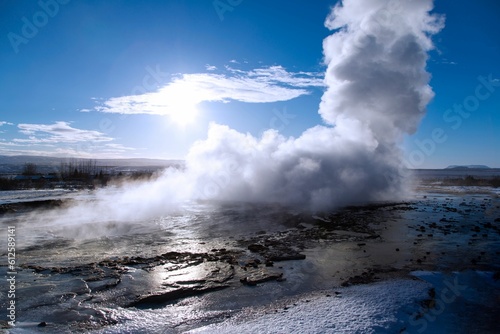 Closeup shot of a hot geysir spring coming out of the earth on a cold winter day