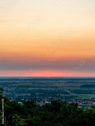 Vertical shot of the sunset sky over the town in summer