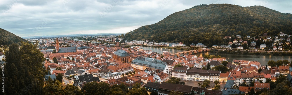 Fototapeta premium Panoramic shot of a beautiful city with a river and mountains surrounding it