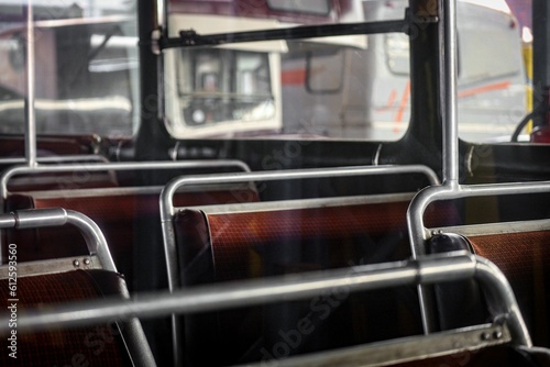 Vintage interior of an old abandoned school bus with red seats