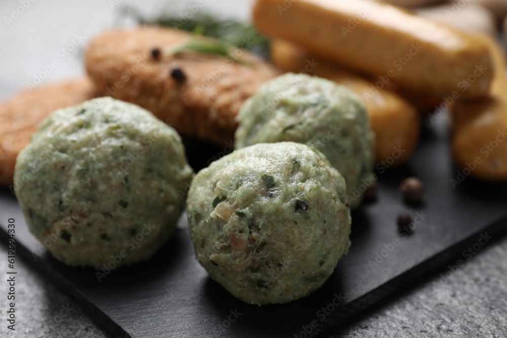 Falafel balls and different raw vegan meat products on dark board, closeup Falafel balls and different raw vegan meat products on dark board, closeup