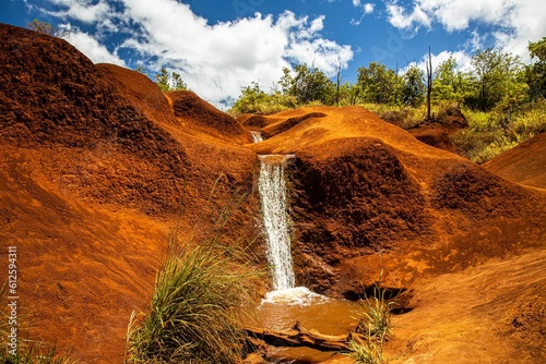 Scenic shot of the red dirt falls in Waimea canyon state park in  Hawaii, USA photo