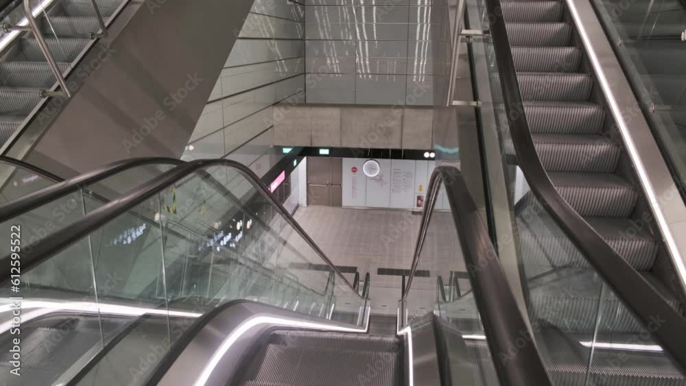 Modern escalators in an empty building in cream shades Modern escalators in an empty building in cream shades