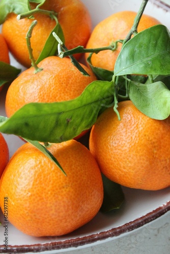 Closeup of fresh tangerines on a white plate