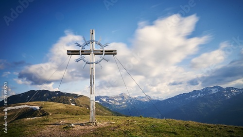 Beautiful shot of a large cross sculpture on a hill in Tyrol