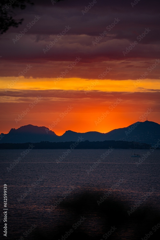 Dramatic scenery of a beautiful sunset in the sky over the sea in Cannes, France