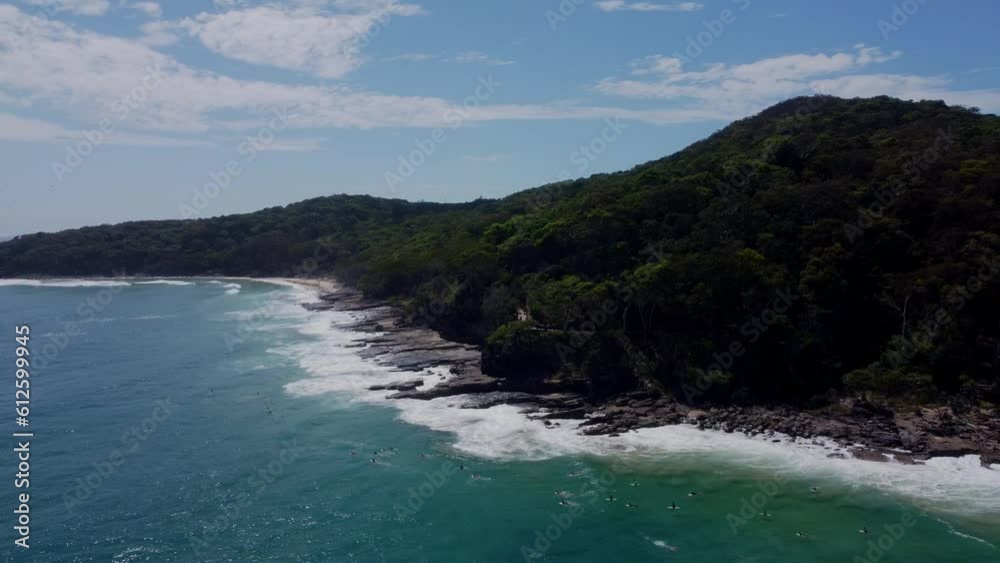 Aerial movement around sea waves breaking beach with growing dense trees Aerial movement around sea waves breaking beach with growing dense trees
