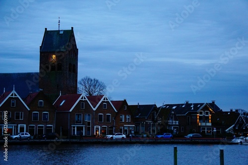 Beautiful view of the buildings by the river in the evening in Grou, Netherlands. photo