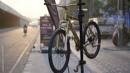 Closeup of a bicycle on a parking pillar on the street