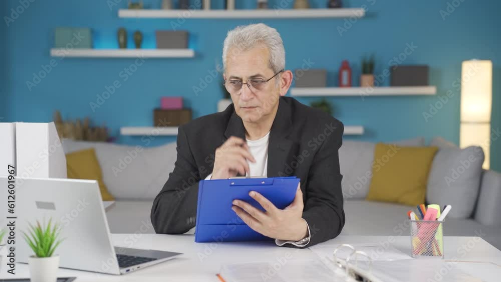 Home office worker man taking notes, jotting down information. Home office worker man taking notes, jotting down information.
