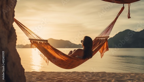 Happy woman relaxing in hammock on the beach