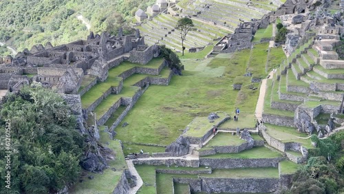 Aerial view of Machu Picchu citadel with breathtaking landscape of mountains under clouds photo