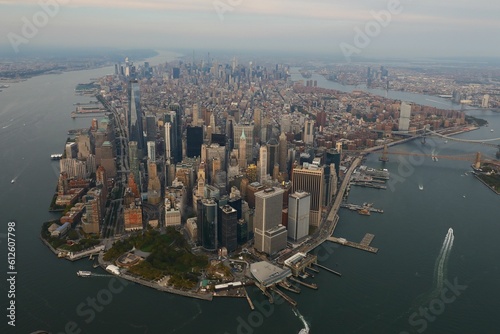 Fototapeta Naklejka Na Ścianę i Meble -  Drone view of the cityscape of New York City with skyscrapers surrounded by water in USA