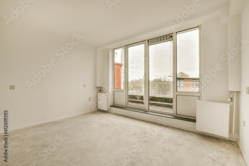 an empty room with large windows and no one person in the room to see what they are looking out at