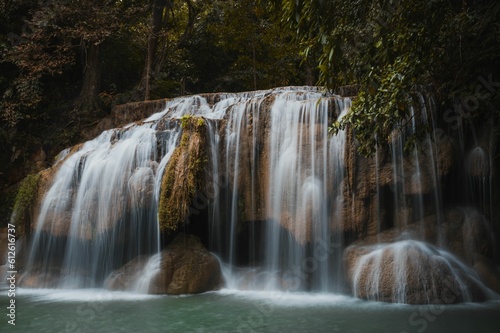 Fototapeta Naklejka Na Ścianę i Meble -  Closeup of a magical waterfall stream on big textured rocks in a forest