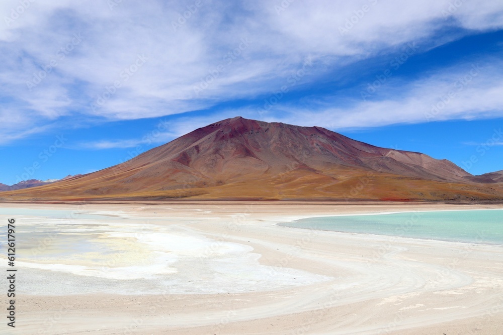 White surface with a sand mountain in the background, Salar de Uyuni, Bolivia White surface with a sand mountain in the background, Salar de Uyuni, Bolivia