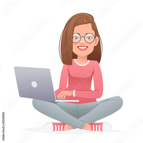 Beautiful happy girl in glasses sits cross-legged with a laptop on her lap. White slender woman sits in a lotus position on the floor and works at a personal computer.