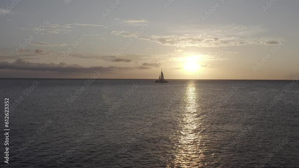 Aerial view of a sailboat on the water at sunset in Aruba