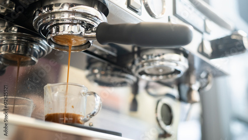 Coffee machine making espresso in a coffee shop, shallow depth of field