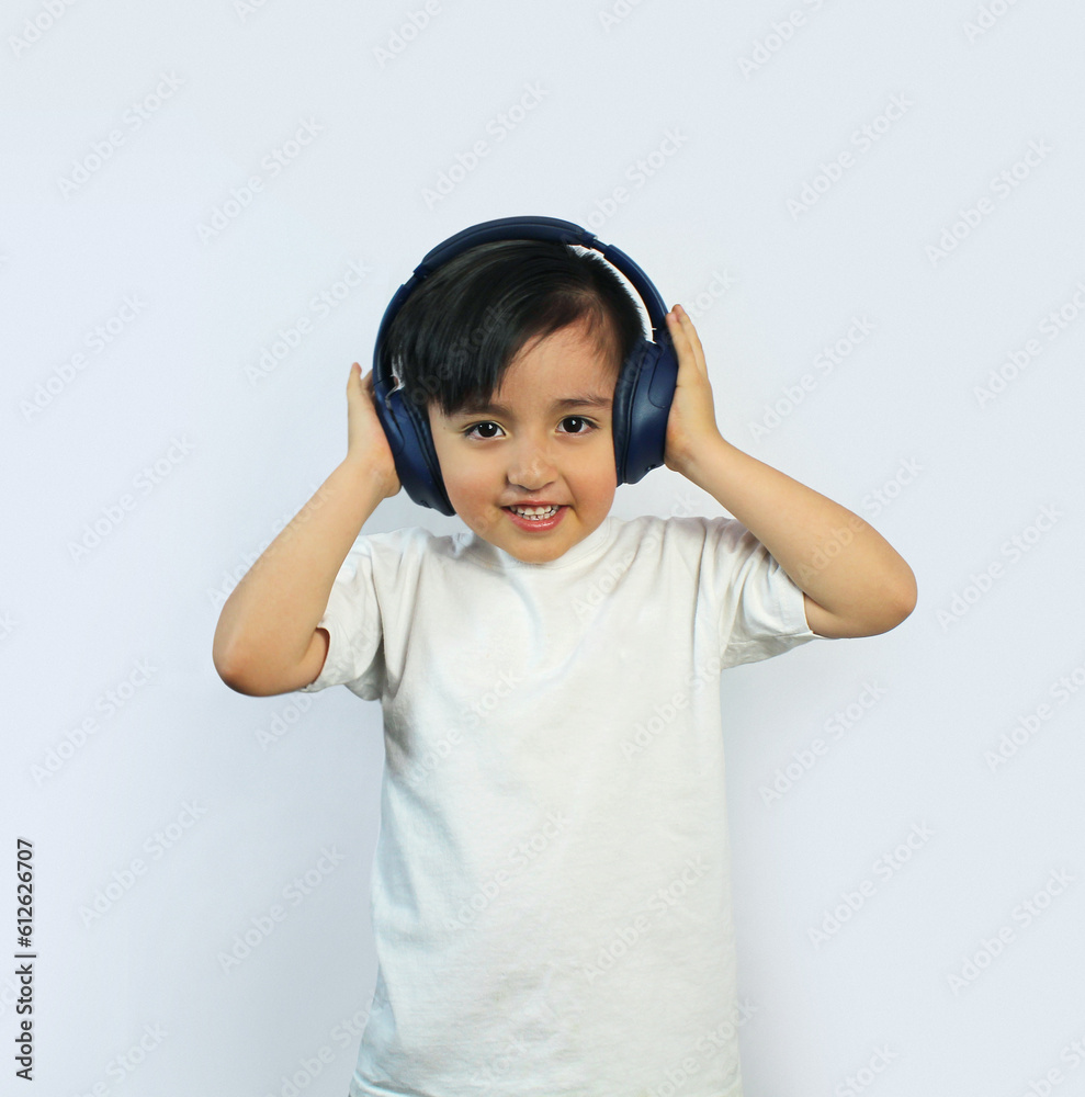 child wearing headphones listening to music, hands squeezing the