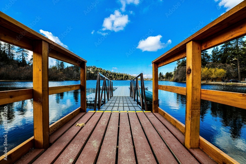 Beautiful view of a wooden platform over a lake under a blue sky with clouds. Beautiful view of a wooden platform over a lake under a blue sky with clouds.