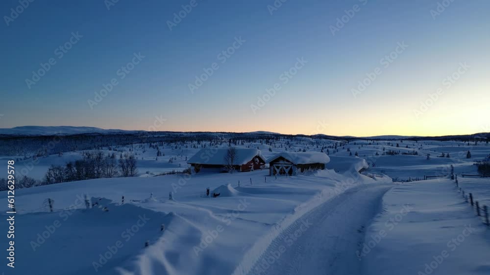 High-angle view of mountains covered by snow and trees during the sunset. High-angle view of mountains covered by snow and trees during the sunset.