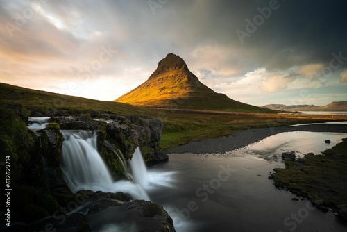Scenic Kirkjufell in the background of a river in Iceland photo
