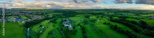 Aerial shot of lush green fields and houses