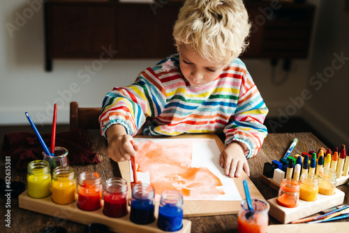 Lovely kid engrossed in painting