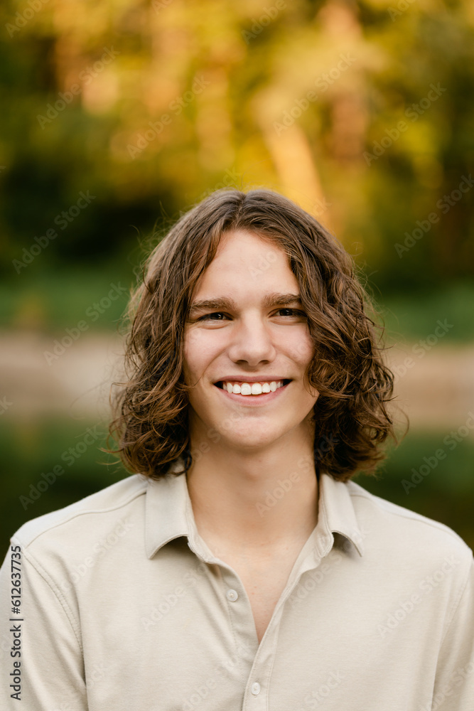 A Teenage Boy Smiles and Looks at the Camera A Teenage Boy Smiles and Looks at the Camera