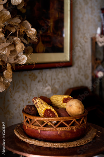Interior decor with old crafted basket and corn photo