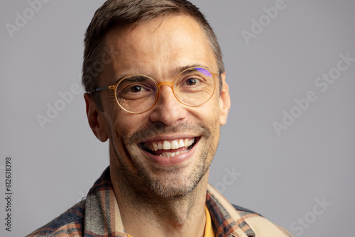 Man in studio smiling sincerely photo