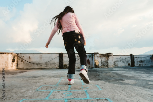 teenage girl crossing a hopscotch