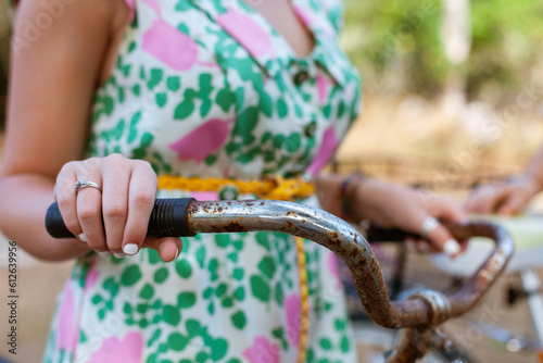 Woman holding bicycle handlebar closeup photo