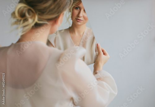 Blond woman with mirror photo