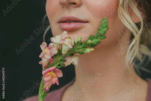 Anonymous woman smelling flowers photo