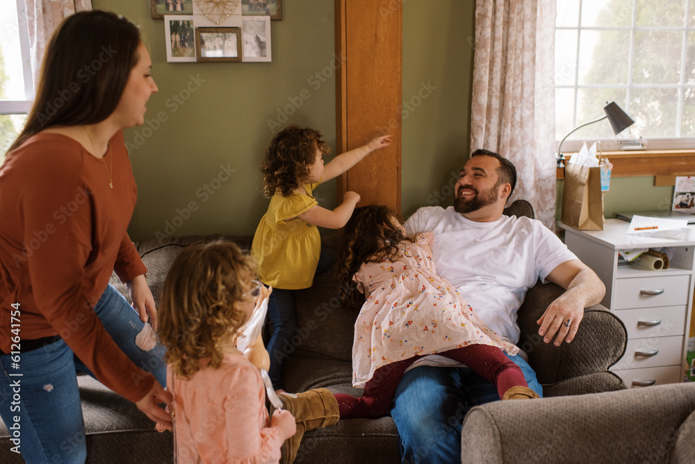 Children playing with their father on sofa at home Children playing with their father on sofa at home