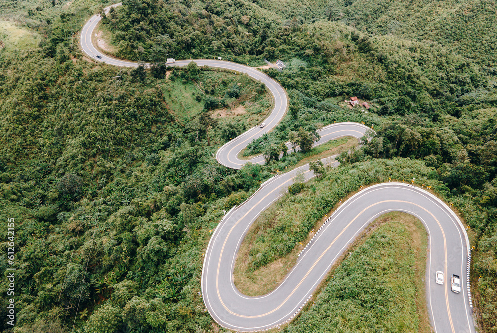 Aerial view of amazing road with green forest and mountain,Bird's eye view from drone