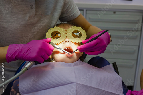 Anonymous doc child patient dentistry procedure medical equipment photo
