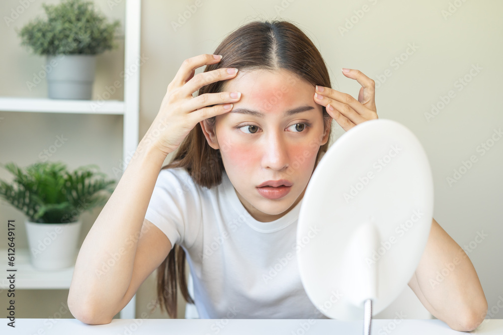 Dermatology, scratch asian young woman looking at mirror, expression worry and itch, itchy allergy or allergic sensitive reaction, red spot or rash on her face. Beauty care from skin problem treatment Dermatology, scratch asian young woman looking at mirror, expression worry and itch, itchy allergy or allergic sensitive reaction, red spot or rash on her face. Beauty care from skin problem treatment