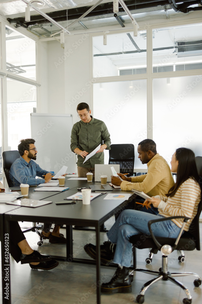 © Oleksii Syrotkin/Stocksy - Businesspeople talk strategy briefing company brainstorming